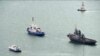 This video grab provided by the Krym 24 tv station via AP Television shows a seized Ukrainian ship, right, is towed by a Russian coast guard boat out of the port in Kerch, Crimea, Nov. 17, 2019. 