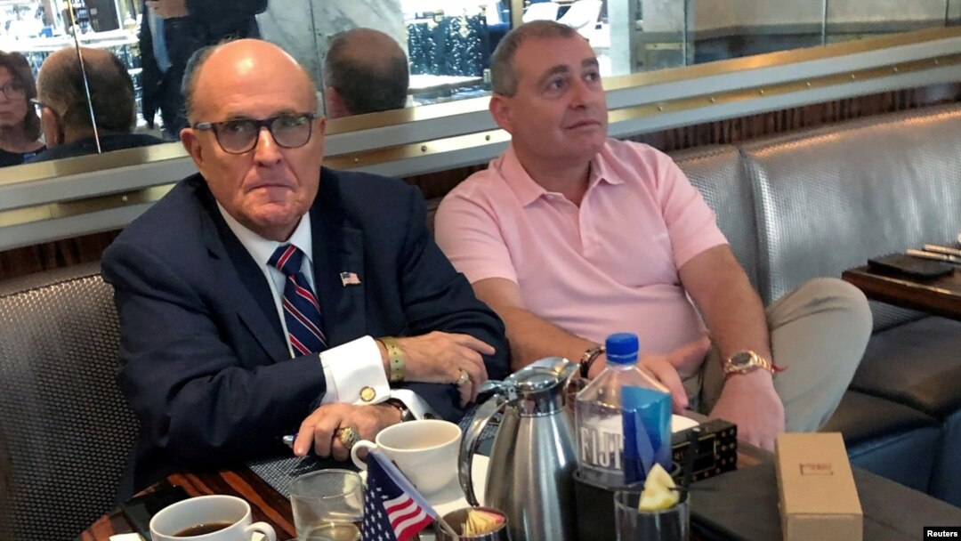 FILE - Rudy Giuliani is seen with Ukrainian-American businessman Lev Parnas at the Trump International Hotel in Washington, Sept. 20, 2019. Parnas has been arrested with another associate of Giuliani's, Igor Fruman, a Belarus-born U.S. citizen.