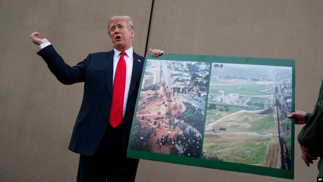 FILE - President Donald Trump talks with reporters as he gets a briefing on border wall prototypes, in San Diego, California March 13, 2018.