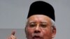 Malaysian Prime Minister Najib Razak (C) inspects party delegates during an annual general assembly in Kuala Lumpur (December 2011 file photo)