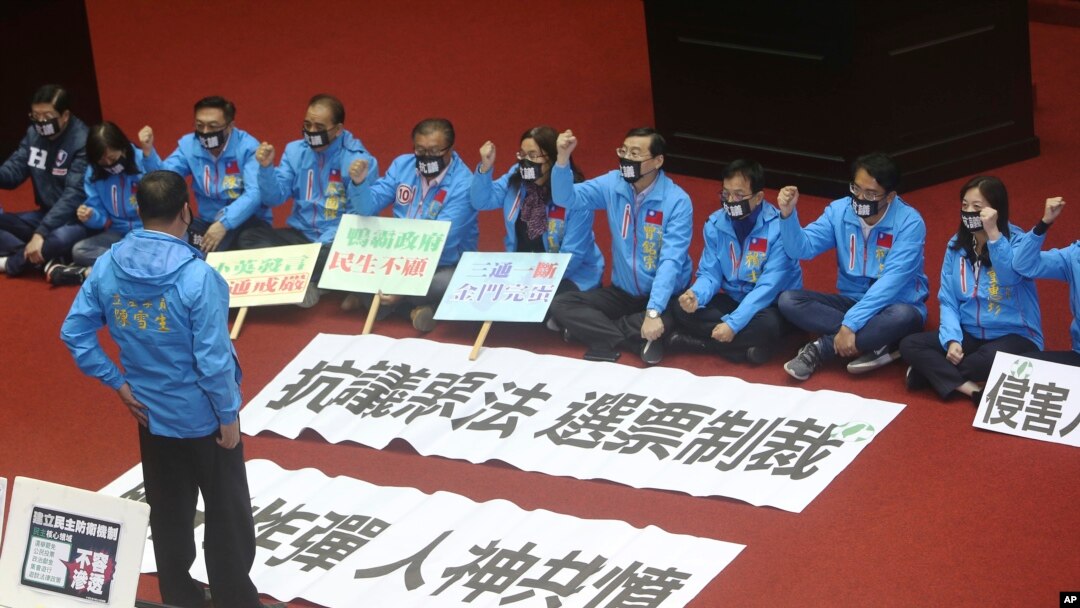 Legislators of the Nationalist Party protest the Anti-infiltration Bill with slogans reading ''Protest against a bad law, Sanction by Votes. Neck Bomb, Be hated by both man and God' on the legislature floor in Taipei, Taiwan, Dec. 31, 2019. 