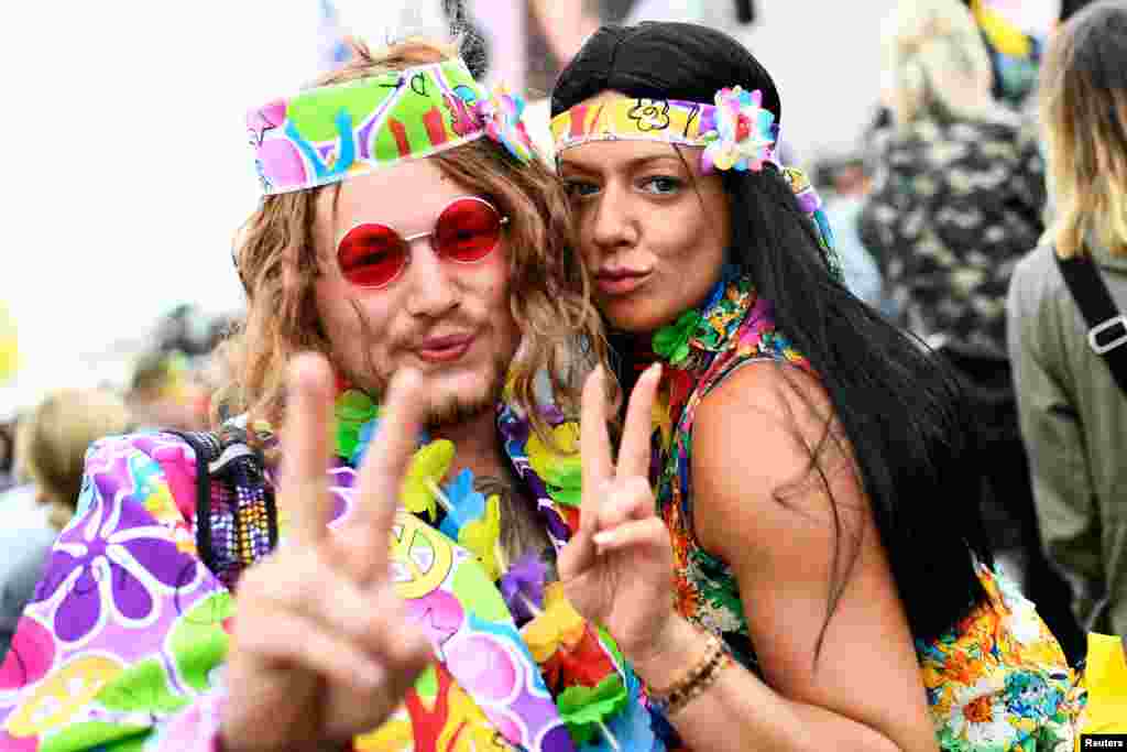 Revelers smile during the Glastonbury Festival at Worthy Farm in Somerset, Britain.