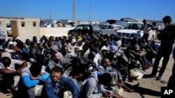 African illegal migrants wait to receive medical help after being rescued by coast guards, in Tripoli, Libya, April 11, 2016. More than 100 migrants were rescued by two coast guard units on Monday after their boat started sinking in the sea. (AP Photo/Mohamed Ben Khalifa) 