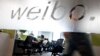FILE - Employees work at their desks at a Sina Weibo office in Beijing. 