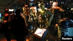 FILE - Characters from the "Star Wars" film series are seen during a press preview for the exhibit "Star Wars Identities" at the MAK museum in Vienna, Austria, Dec. 17, 2015. "Star Wars" filmmaker George Lucas has chosen Los Angeles to host his new museum, which will feature paintings, illustrations and digital art from the movie franchise.