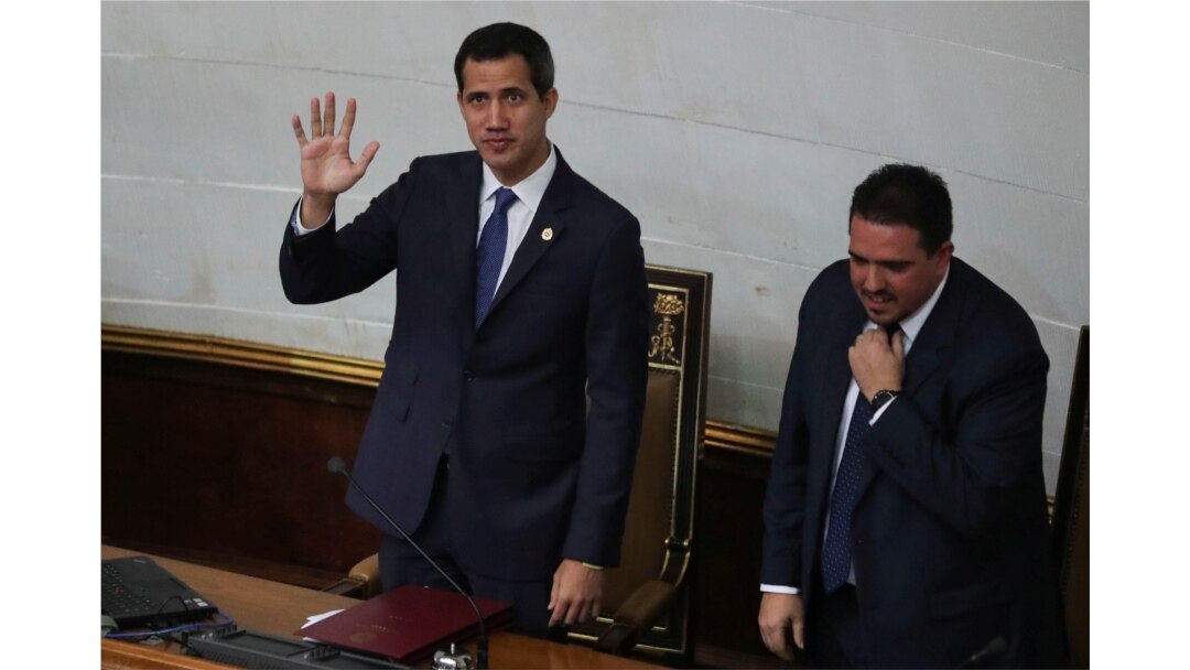 Venezuelan opposition leader Juan Guaido waves next to Stalin Gonzalez, second Vice President of the National Assembly, as they attend a session of the National Assembly in Caracas, Sept. 24, 2019.