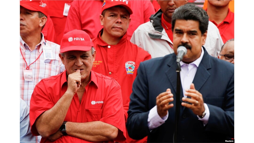 FILE -- Venezuela's Oil Minister and President of the Venezuelan state oil company PDVSA, Eulogio del Pino stands next to Venezuela's President Nicolas Maduro during a pro-government rally with workers of state-run oil company PDVSA in Caracas, Venezuela,