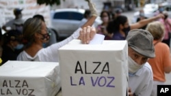 An elderly man votes in a consultation organized by the opposition to reject the government of President Nicolas Maduro in Caracas, Venezuela, Dec. 12, 2020.