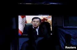 Cambodia's Prime Minister Hun Sen is seen on a television as he delivers a speech, at a restaurant in central Phnom Penh, Oct. 28, 2015.