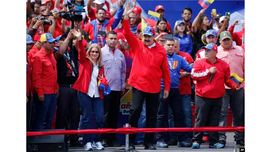 President Nicolas Maduro and first lady Cilia Flores greet supporters as they arrive at a rally in Caracas, Venezuela, Feb. 2, 2019.