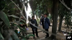 Indian investigators visit a spot which police say is where a Danish tourist was gang-raped in New Delhi, India, Jan. 15, 2014.