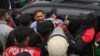 Police detain a supporter of former prime minister Imran Khan's Pakistan Tehreek-e-Insaf (PTI) party, at a protest against the alleged skewing in Pakistan's national election, in Lahore, on March 10, 2024.