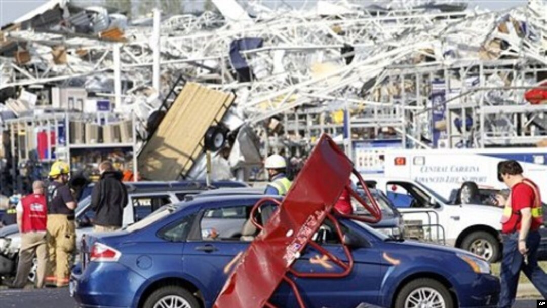 Emergency personnel work around a Lowes Home Improvement store after it was hit by a tornado in Sanford, North Carolina, April 16, 2011