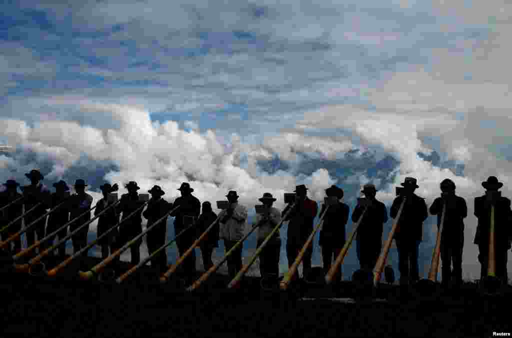 Alphorn blowers perform an ensemble piece on the last day of the Alphorn International Festival on the alp of Tracouet in Nendaz, southern Switzerland.