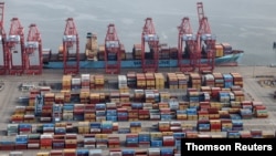 File Photo: Shipping containers are unloaded from a ship at a container terminal at the Port of Long Beach-Port of Los Angeles complex, amid the coronavirus disease (COVID-19) pandemic, in Los Angeles.