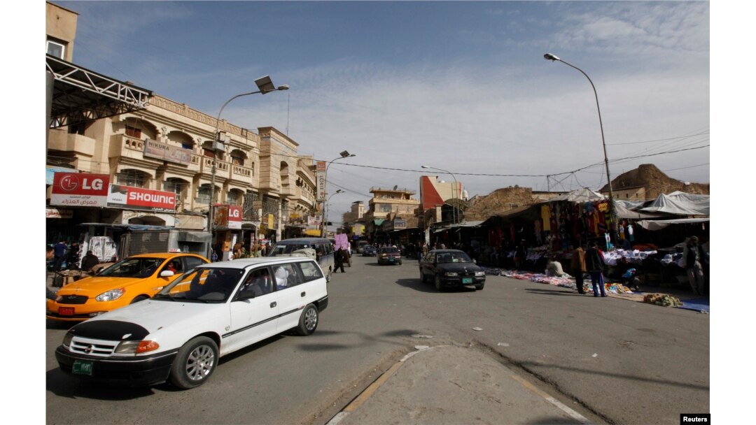 FILE - Vehicles drive past on a street in Mosul, 390 km (240 miles) north of Baghdad, March 12, 2012. Islamic State militants occupied the city in mid-2014.