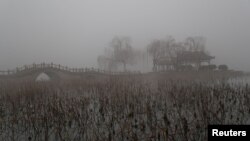 FILE - Heavy smog is seen during a polluted day at the Daming Lake in Jinan, Shandong province, China, Jan. 5, 2017. 