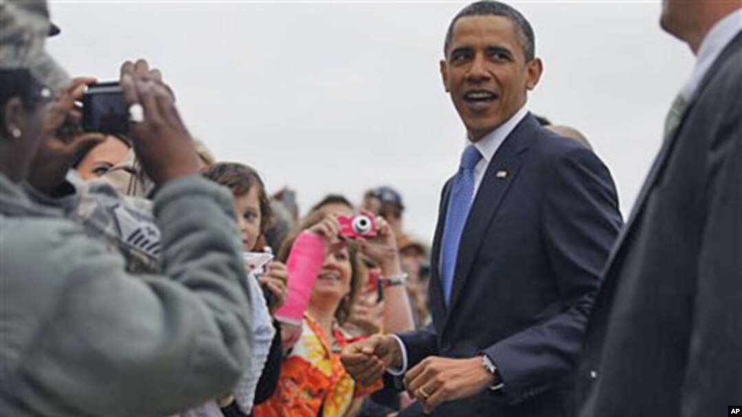 President Barack Obama greets well wishers upon arrival in Memphis, Tenn., where he met privately with families affected by flooding, and delivered the commencement address at Booker T. Washington High School, May 16, 2011