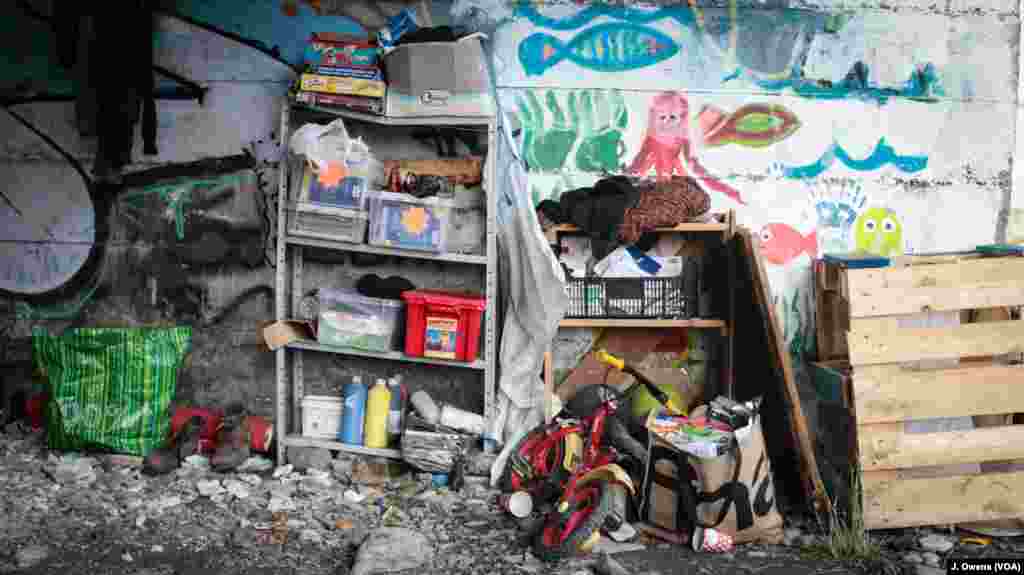 Books, board games and other forms of entertainment — most of it donated by volunteers — are piled up by the underpass Ventimiglia, Italy.
