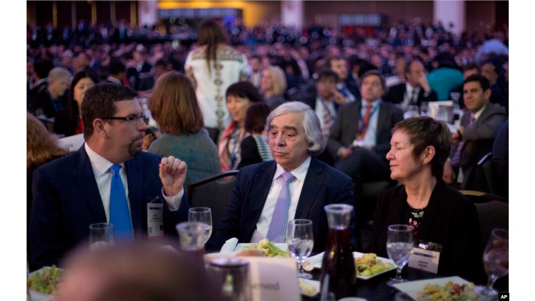 Energy Secretary Ernest Moniz, center, sits with other guests at the SelectUSA investment summit in Washington, June 20, 2016.