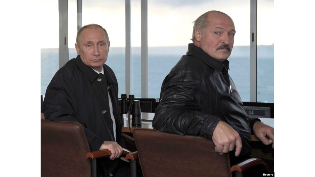 FILE - Russia's President Vladimir Putin, left, and Belarus' President Alexander Lukashenko watch the joint war games Zapad-2013 (West-2013) at Khmelevka base in the Kaliningrad Region, Sept. 26, 2013.