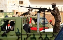 Sudanese soldiers secure the area as Sudan's ex-president Omar al-Bashir leaves the office of the anti-corruption prosecutor in Khartoum, Sudan, June 16, 2019.