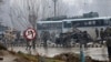 Indian paramilitary soldiers stand by the wreckage of a bus after an explosion in Pampore, Indian-controlled Kashmir, Feb. 14, 2019. 