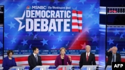 FILE - Sen. Elizabeth Warren (D-MA) (C) speaks as Sen. Amy Klobuchar (D-MN) (L), South Bend, Indiana Mayor Pete Buttigieg, former Vice President Joe Biden and Sen. Bernie Sanders (I-VT) (R) listen, Nov. 20, 2019 in Atlanta, Georgia. 