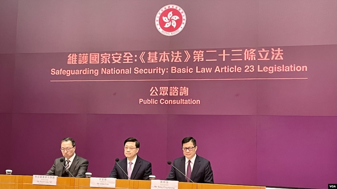 香港特首李家超（中）今年1月底率領律政司司長林定國（左）以及保安局局長鄧炳強召開記者會，正式宣布展開為期29日的《基本法》23條立法公眾諮詢。（美國之音照片）