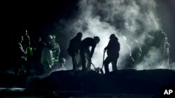 Staff of Pemex, Petroleos Mexicanos, works the area of a oil pipeline explosion in Tlahuelilpan, Hidalgo state, Mexico, Jan. 19, 2019. 