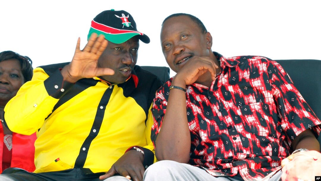 The National Alliance Party (TNA) presidential candidate Deputy Prime Minister Uhuru Kenyatta right, and his running mate William Ruto, talk during a rally at Uhuru Park, in Nairobi, January 12, 2013.