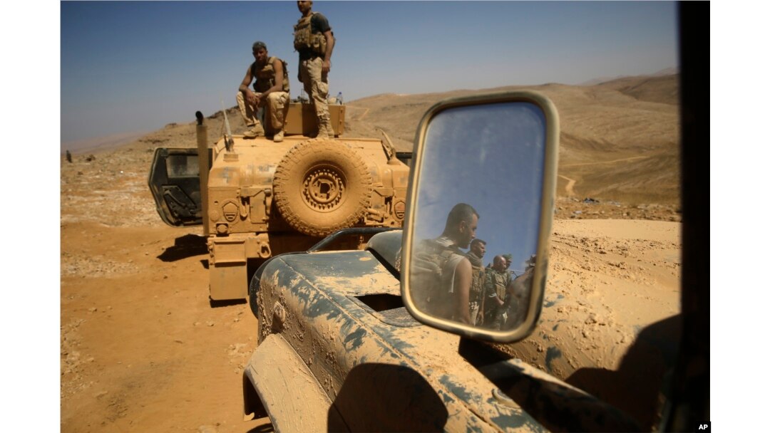 Lebanese soldiers rest on top of an armored personnel carrier during a media trip organized by the Lebanese army, on the outskirts of Ras Baalbek, northeast Lebanon Aug. 28, 2017. The Islamic State group has been expelled from its redoubt in the Qalamoun region close to the Syrian border.