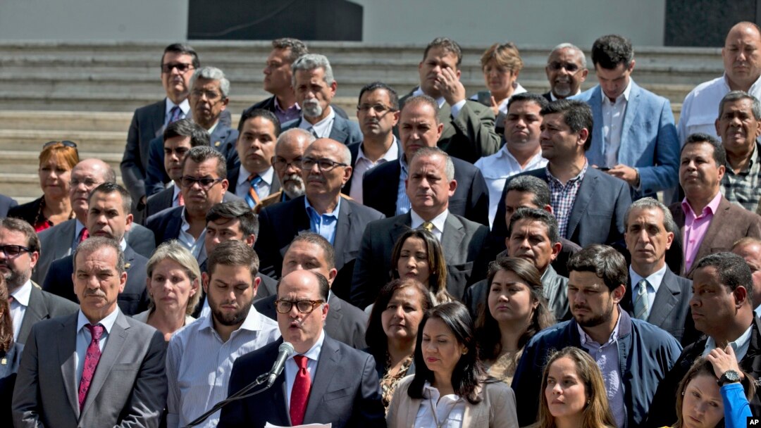 Venezuela's National Assembly President Julio Borges, center, surrounded by fellow legislators, speaks during a meeting with the media, in Caracas, Venezuela, April 18, 2017.