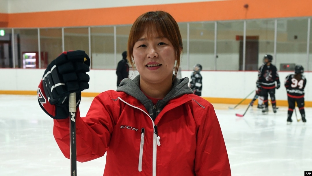 Former North Korean ice hockey player Hwangbo Young, center, coaches an ice hockey class for children at an ice rink in Seoul. When the North and South Korean women's hockey teams clash in a rare match this week, defector-turned-star-player Hwangbo Young will cheer for the country that has labeled her a traitor.