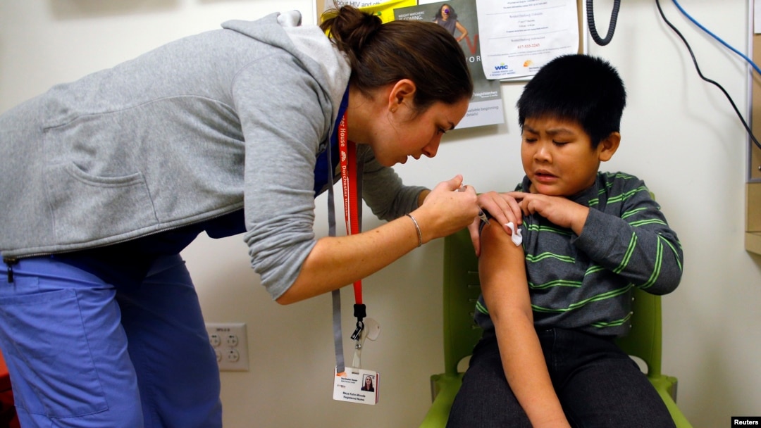 FILE - A boy gets an influenza vaccine injection at a health care clinic in Boston, Massachusetts, Jan. 12, 2013.