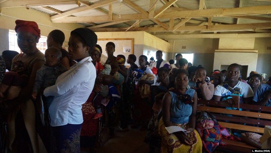 FILE - Mothers queue to have their children vaccinated against malaria at Likuni Community Hospital in Lilongwe, Malawi.