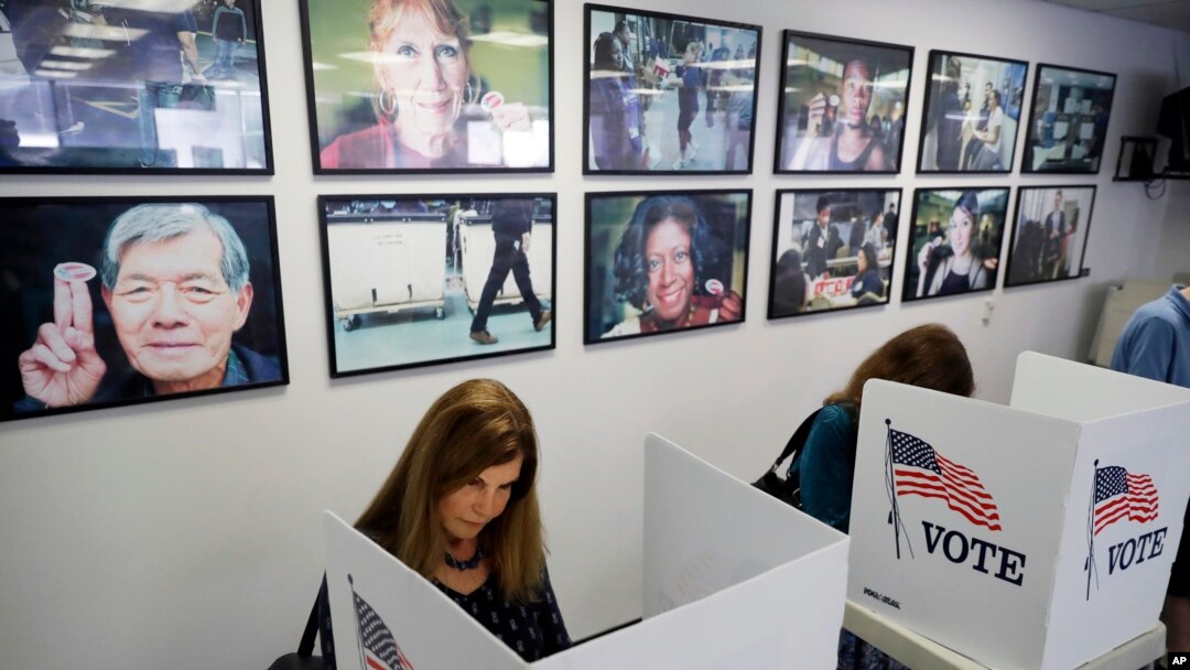 FILE - Voters fill out their ballots at the Los Angeles County Registrar of Voters office in Norwalk, Calif. 