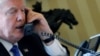 U.S. President Donald Trump speaks by phone with Russia's President Vladimir Putin in the Oval Office at the White House in Washington, Jan. 28, 2017. 