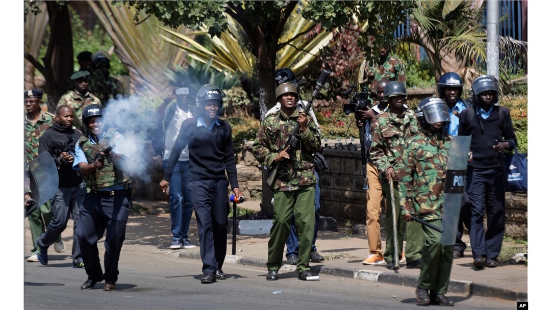FILE - Kenyan riot police fire tear gas at opposition protesters during a rally near electoral commission offices in downtown Nairobi, Kenya, Sept. 26, 2017.