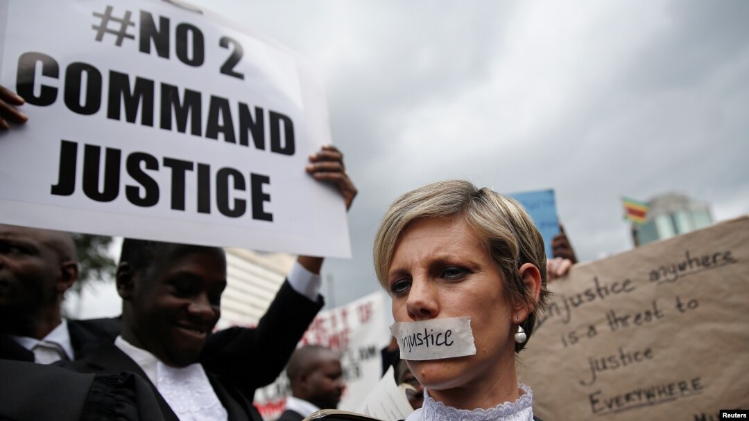 Zimbabwean lawyers carry placards as they march to demand justice for people detained in jail and others facing fast-track trials following recent protests in Harare, Zimbabwe, Jan. 29, 2019. 