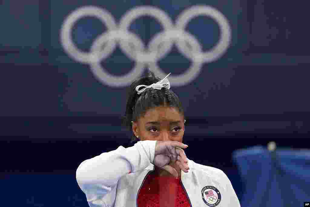 Simone Biles of the United States watches gymnasts perform at the 2020 Summer Olympics, in Tokyo. Biles says she wasn't in right "headspace" to compete and withdrew from the gymnastics team final.