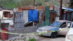 The body of Mexican photojournalist Margarito Martinez Esquivel (obscured) lies on the ground next to his car after he was killed outside his home, in Tijuana, Mexico, Jan. 17, 2022.