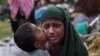 FILE - A Rohingya Muslim child kisses his mother as they rest after having crossed over from Myanmar to the Bangladesh side of the border near Cox's Bazar's Teknaf area, Sept. 2, 2017. Tens of thousands of others crossed into Bangladesh in a 24-hour span as they fled violence in western Myanmar, the UNHCR said. 
