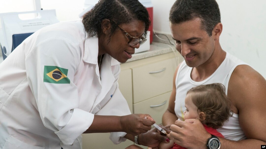 A nurse vaccinates a toddler against yellow fever at a public health clinic in Rio de Janeiro, Brazil, March 16, 2017.