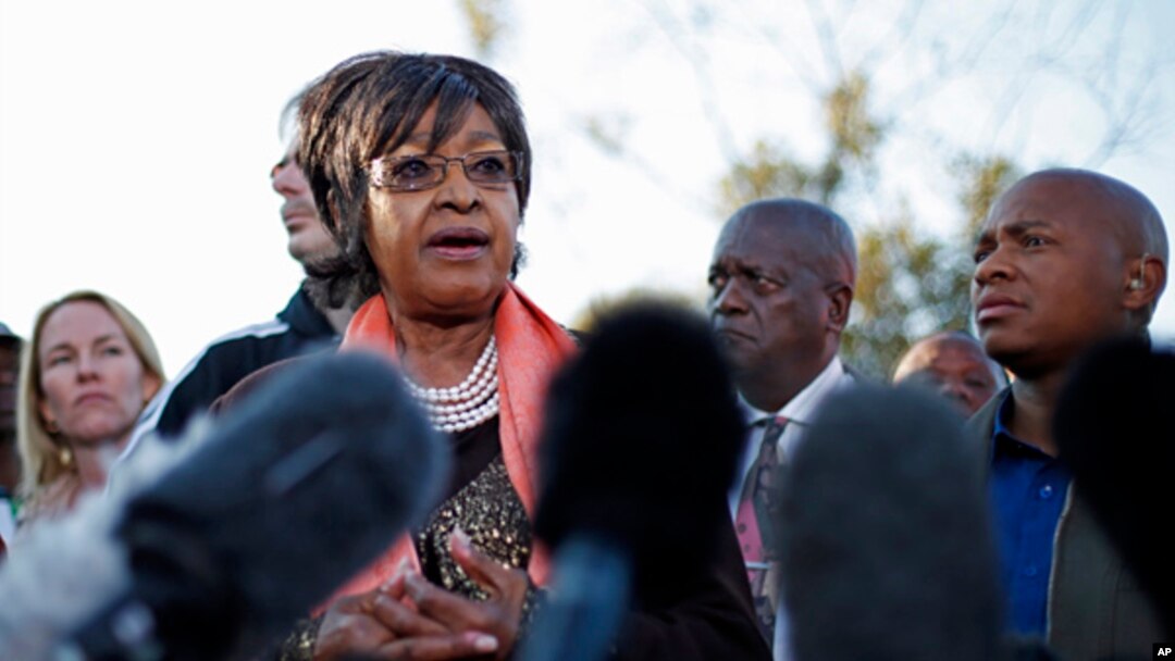 Winnie Madikizela-Mandela addresses the media in front the house of her former husband and former South African President Nelson Mandela in Soweto, June 28, 2013. 