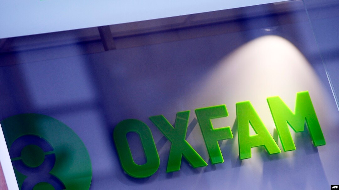 FILE - An Oxfam logo is seen on one of the organization's bookshops in Glasgow, Scotland, Feb. 10, 2018.