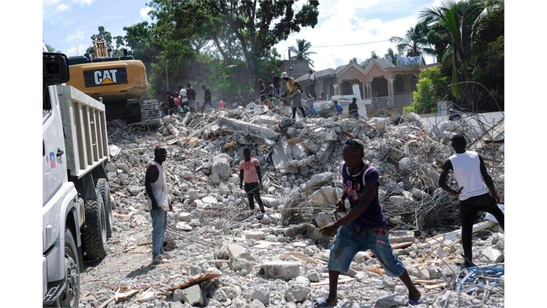 People remove debris at the collapsed Le Manguier hotel in Les Cayes, Haiti, Aug. 16, 2021, two days after a 7.2-magnitude earthquake struck the southwestern part of the country.