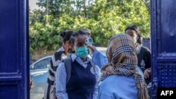 A student has her temperature measured before entering the school premises at the Ethio Parents elementary and high school in Addis Ababa, Ethiopia, on October 26, 2020.
