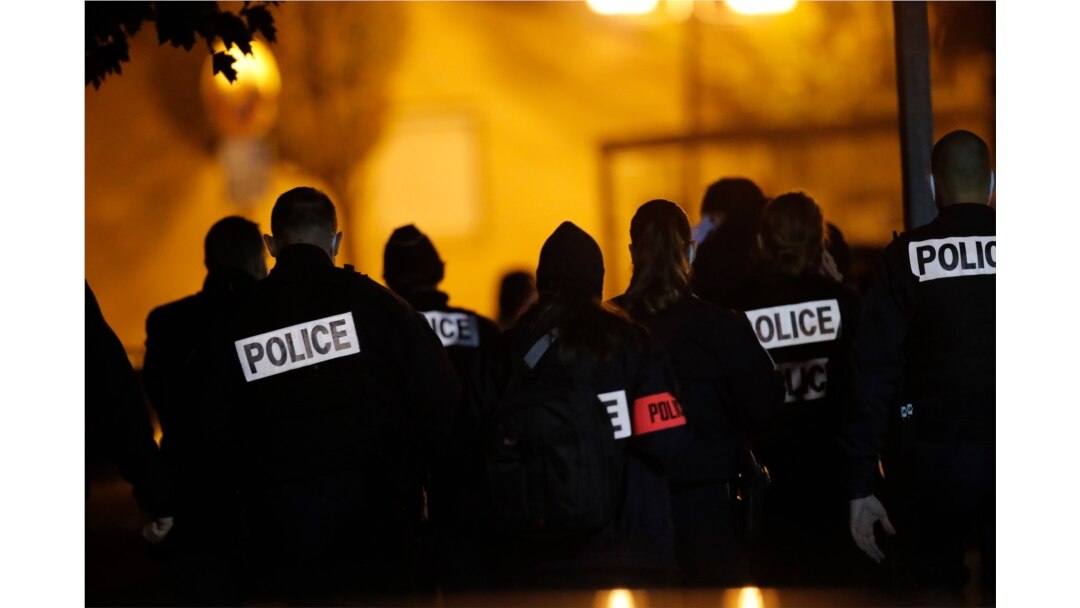 French police officers gather outside a high school after a history teacher who opened a discussion with students on caricatures of Islam's Prophet Muhammad was beheaded, in Conflans-Saint-Honorine, north of Paris, Oct. 16, 2020.