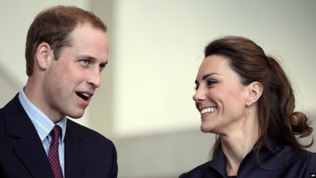 Britain's Prince William speaks, watched by his fiancee Kate Middleton at the Darwen Aldridge Community Academy, in Darwen, northern England, April 11, 2011